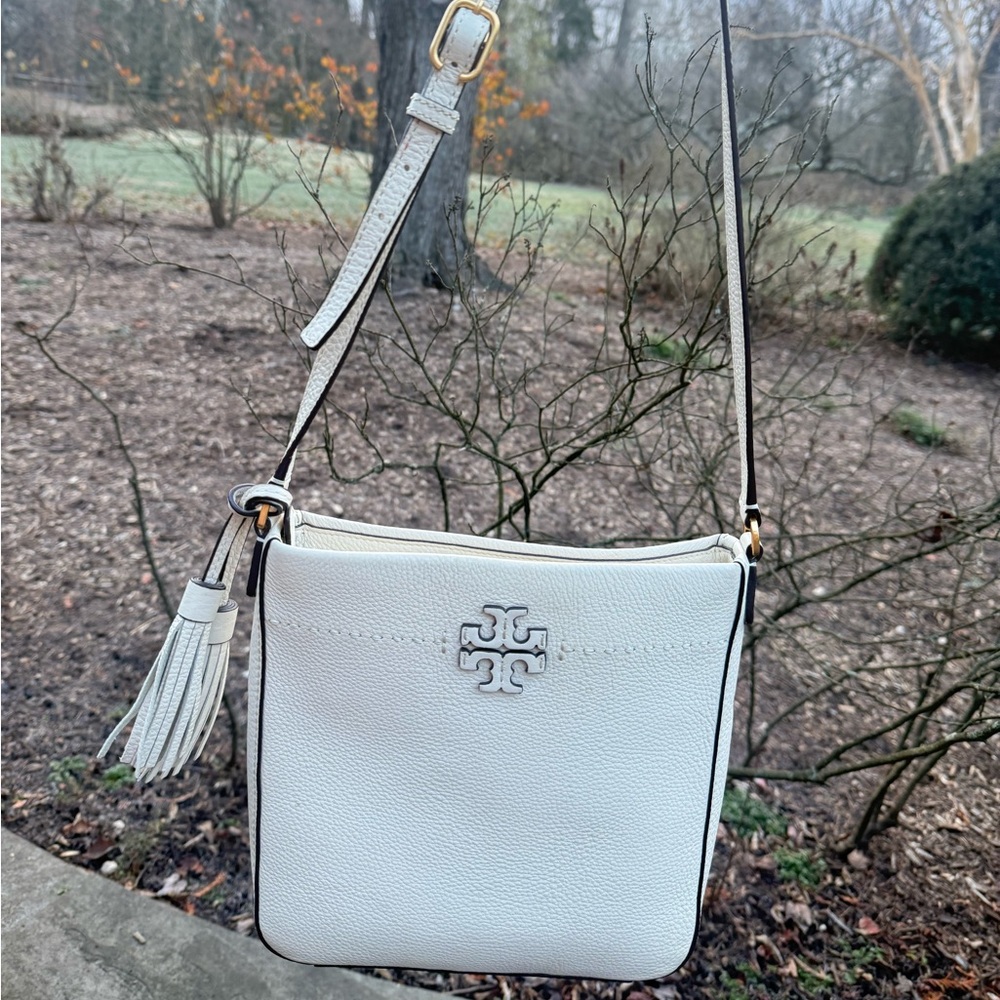 Tory Burch cross body purse with Tassels. Stunningly Ivory color.